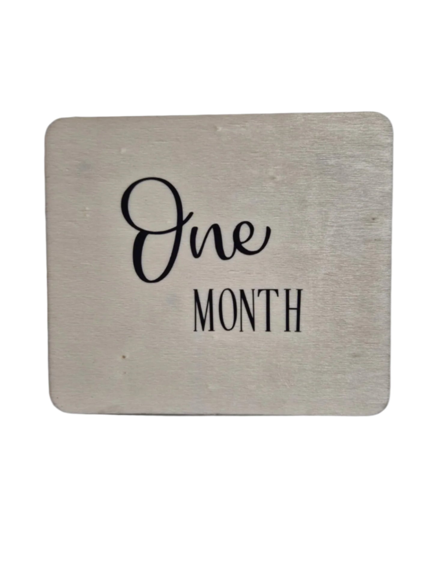 Wooden milestone cards labeled from one month to twelve months